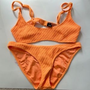 Orange triangl bikini. Size extra small top and size small bottoms.